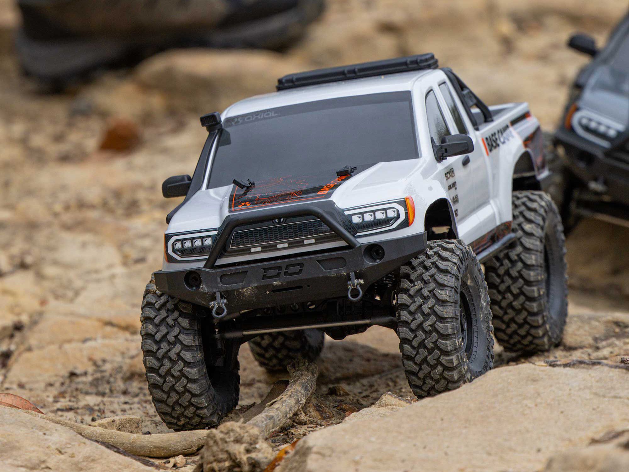 Axial SCX10 III Base Camp trail shot on rough terrain.